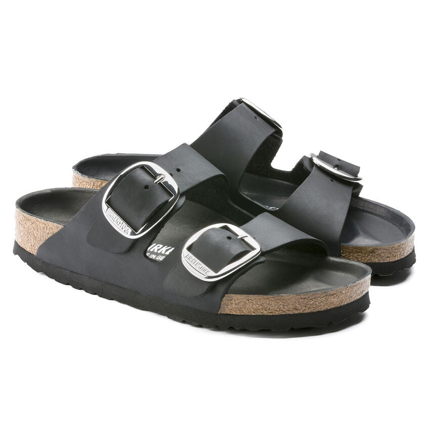 Black Birkenstock sandals with dual buckle straps and cork footbeds.