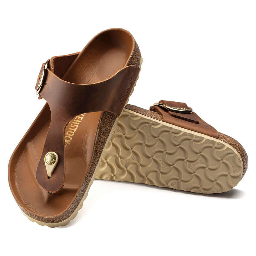 Brown leather sandals with cork soles and adjustable buckle straps on top and bottom views