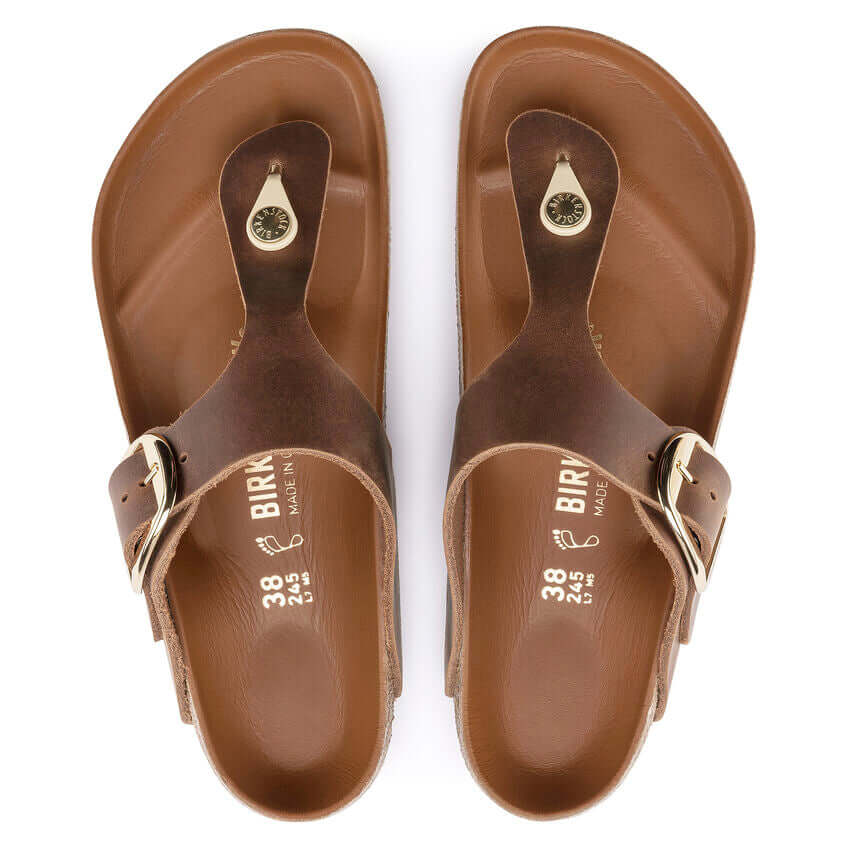 Brown leather Birkenstock sandals with toe loop and buckle clasp, size 38.